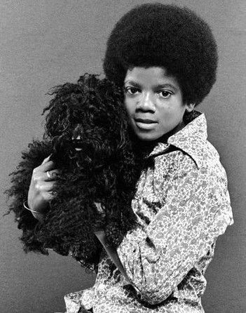 Michael holding a shaggy dog.