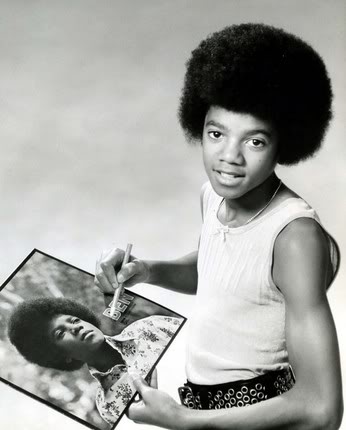 Michael as a young boy signing an autograph